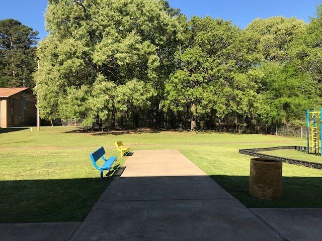 Playground with benches at Ward Plaza Apartments