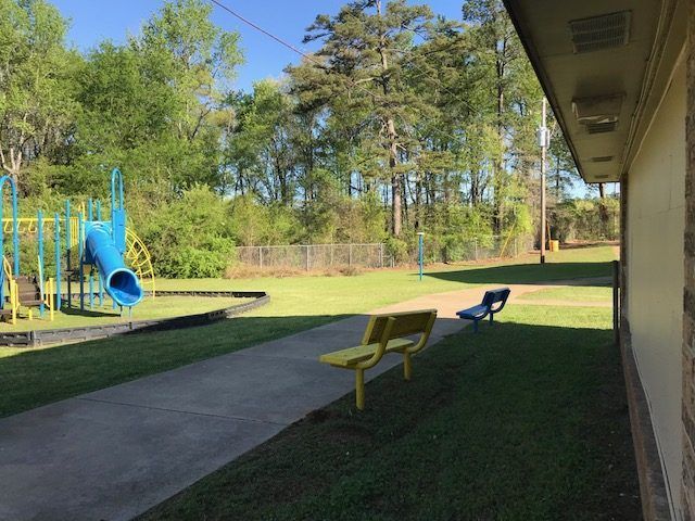 Playground with benches at Ward Plaza Apartments